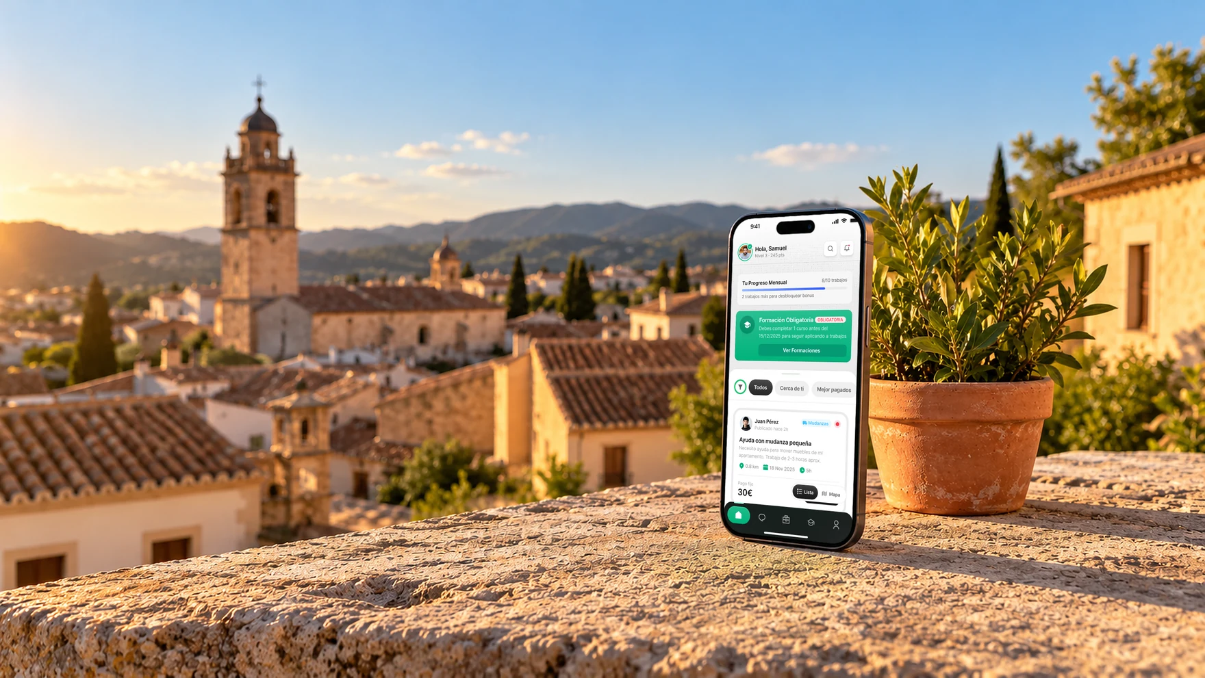 The Microjob home screen on an iPhone standing on a sunny balcony ledge, over the rooftops of a small town