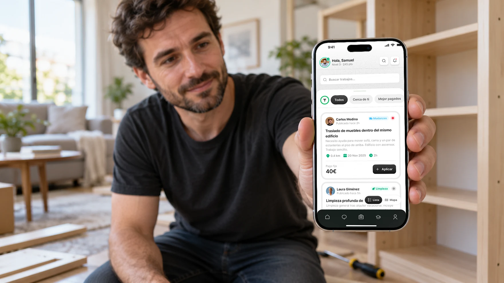 A man assembling a shelf at home, checking the Microjob app on his phone