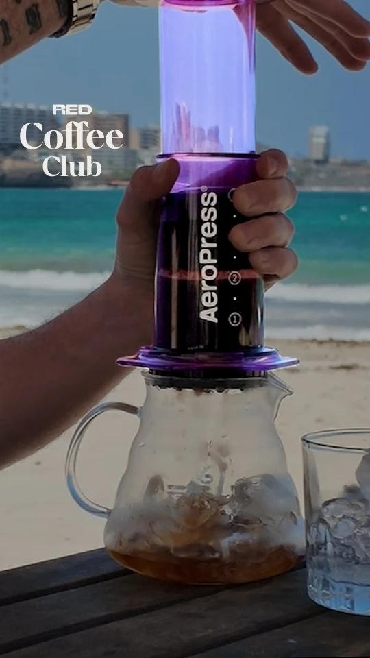 An AeroPress on the beach